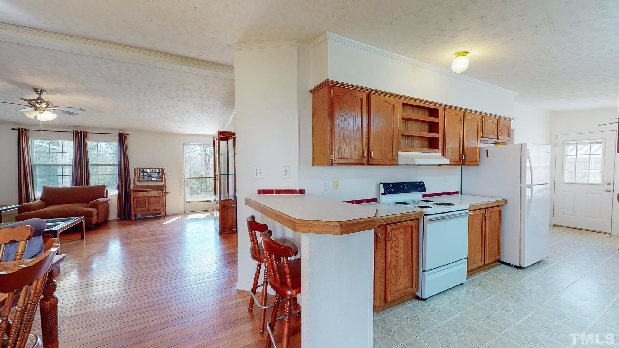 214 Hassel Clayton Road Roxboro, NC 27574 - Photo 6 of 38 a kitchen with a sink stove and wooden floor