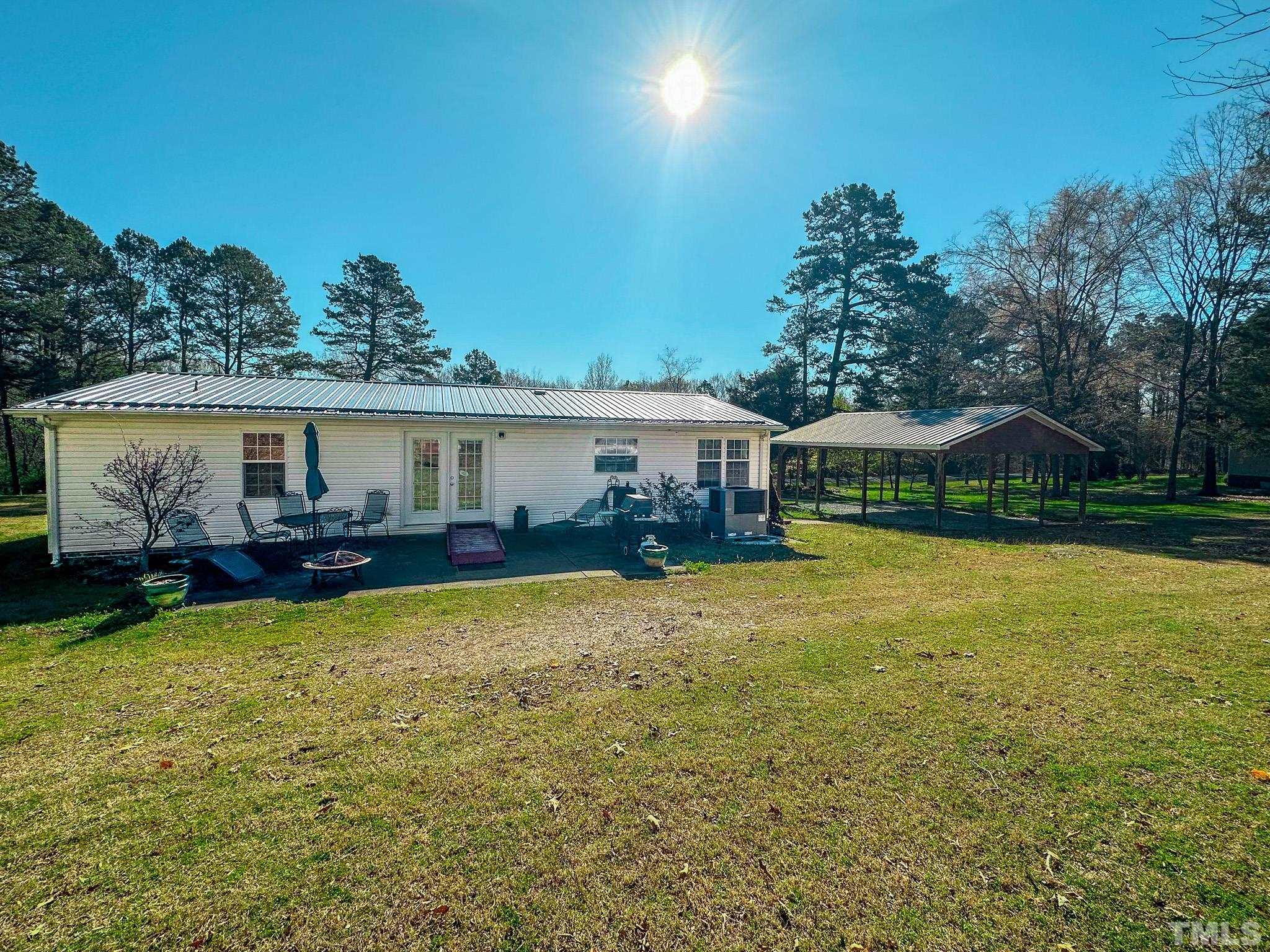 214 Hassel Clayton Road Roxboro, NC 27574 - Photo 7 of 38 a view of a house with backyard patio and swimming pool