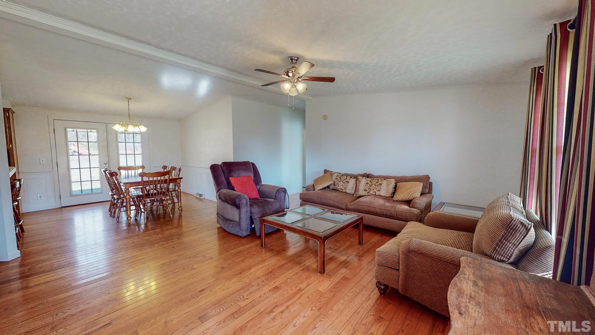 214 Hassel Clayton Road Roxboro, NC 27574 - Photo 8 of 38 a living room with furniture and wooden floor