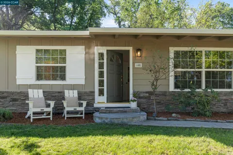 a front view of a house with a yard table and chairs