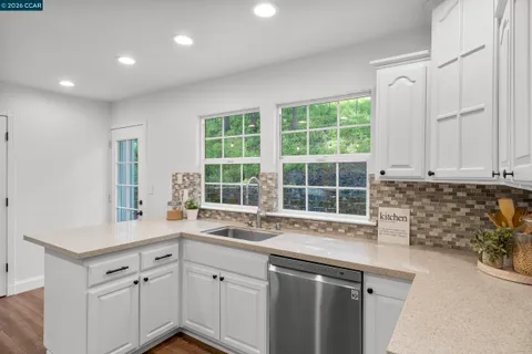 a kitchen with a sink stove and cabinets