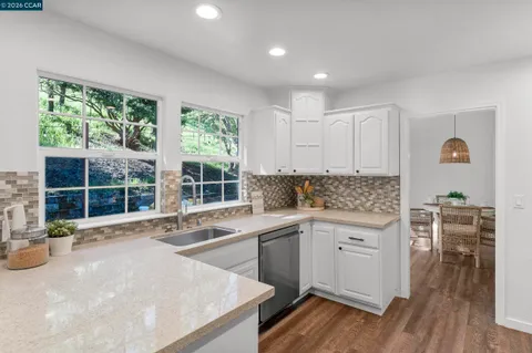 a kitchen with stainless steel appliances granite countertop a refrigerator stove and sink