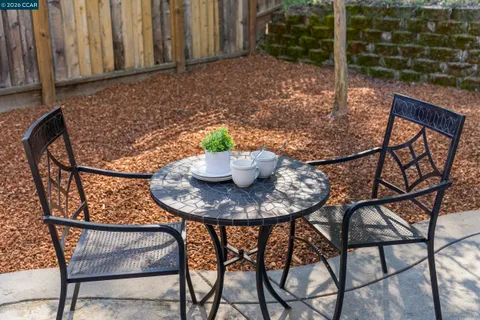 a backyard of a house with fire pit and outdoor seating