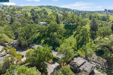 an aerial view of a house with a yard