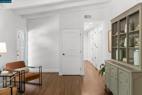 a living room with furniture a rug and a table