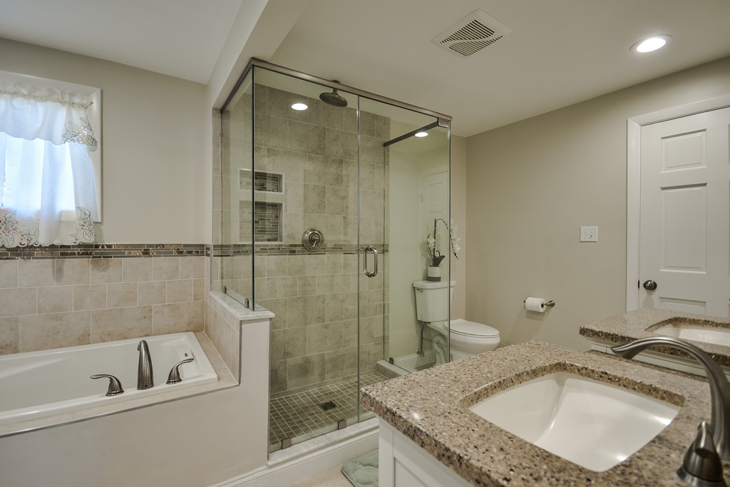 18 Gary Road Needham, MA 02494 - Photo 21 of 29 a bathroom with a granite countertop sink a mirror and bathtub
