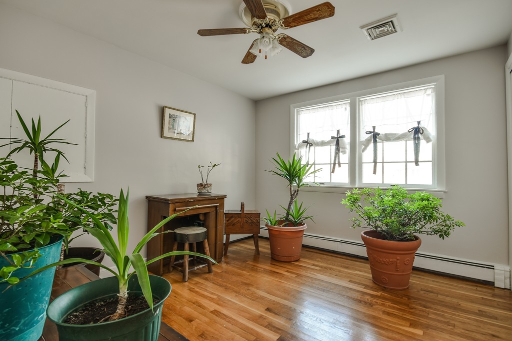 18 Gary Road Needham, MA 02494 - Photo 23 of 29 a dining room with furniture potted plants and wooden floor