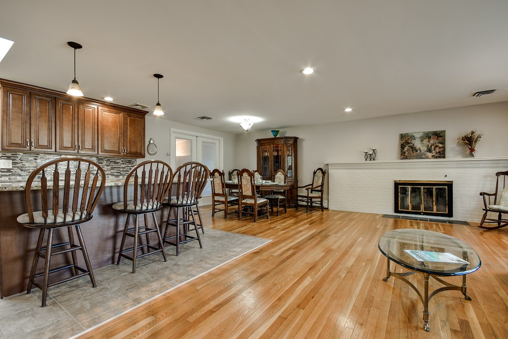 18 Gary Road Needham, MA 02494 - Photo 3 of 29 a living room with furniture a fireplace and a dining table with wooden floor