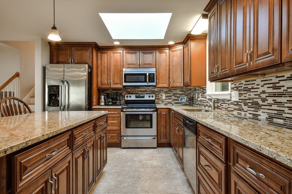 18 Gary Road Needham, MA 02494 - Photo 10 of 29 a kitchen with stainless steel appliances granite countertop a stove a sink and a microwave