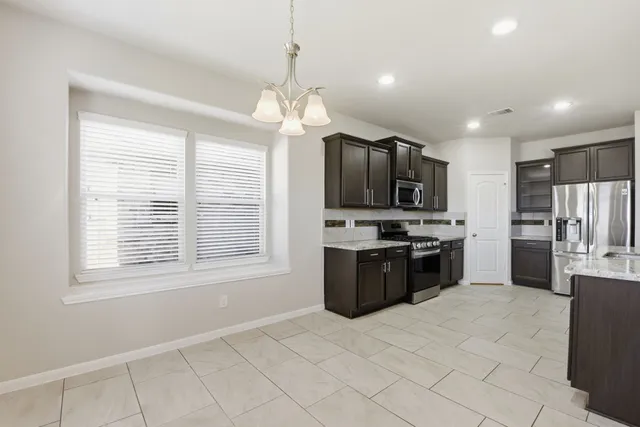 a kitchen with stainless steel appliances a sink and a refrigerator