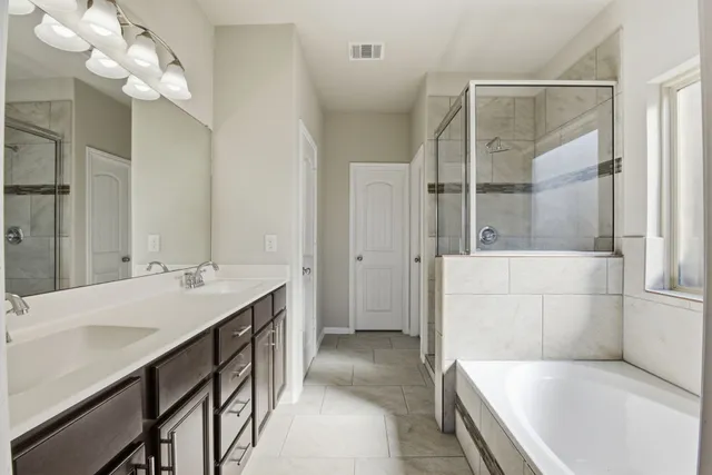 a bathroom with a tub and shower