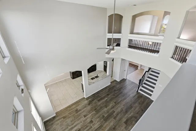 a living room with furniture and a ceiling fan