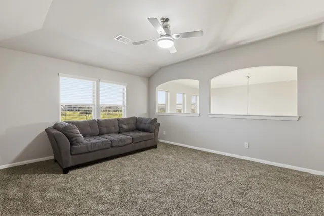 an empty room with closet and a ceiling fan