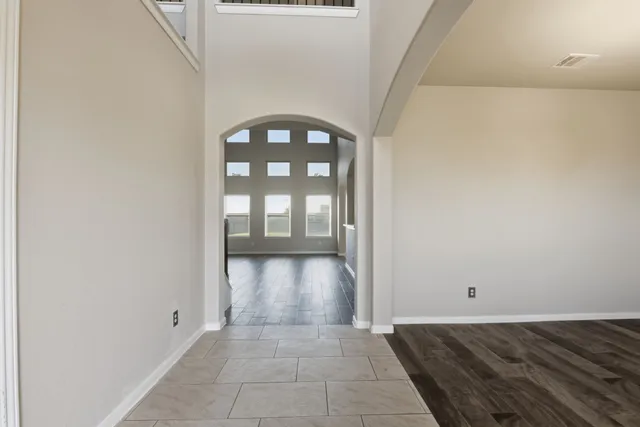 a view of an empty room with glass door