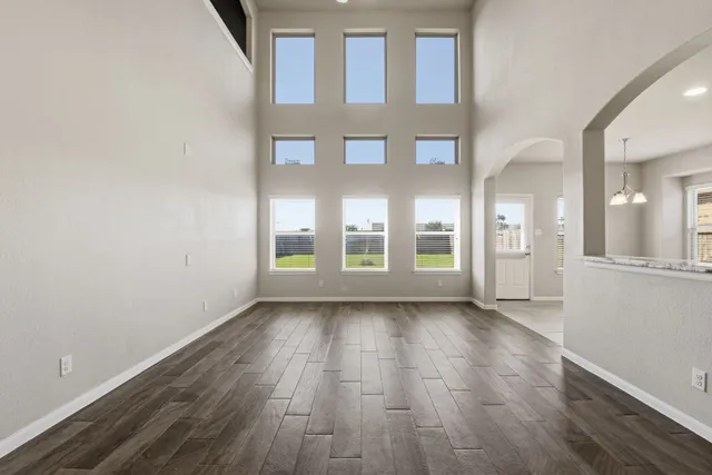 a view of an entryway with wooden floor and a kitchen