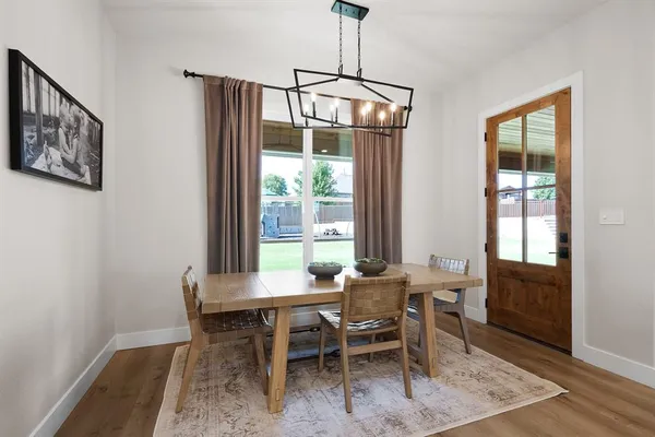 a bedroom with a bed and a flat tv screen on dresser
