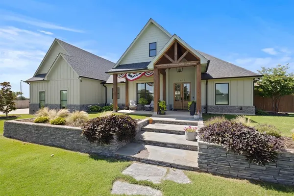 a front view of a house with garden