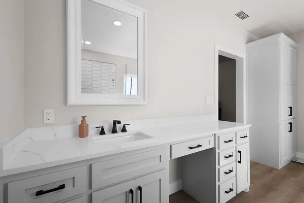 a bathroom with a sink a toilet and a mirror