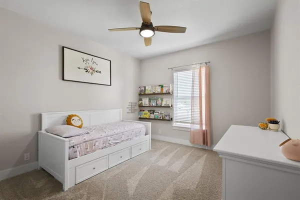 a bed sitting in a bedroom next to a window
