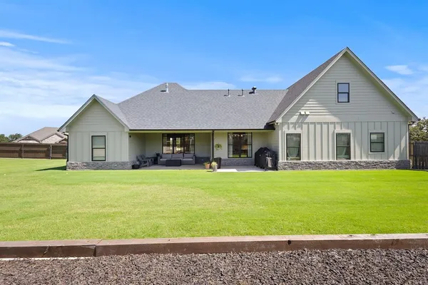 a view of backyard of house with green space