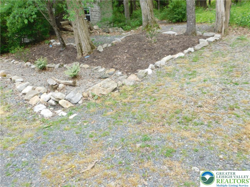 41 Reeder Street Mount Pocono, PA 18344 - Photo 15 of 41 A natural rock border gracefully defines planting beds amidst the surrounding landscape.