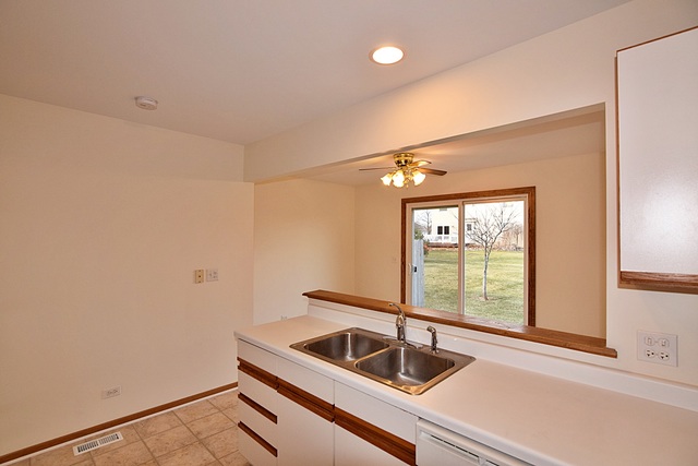 539 Elizabeth Street Maple Park, IL 60151 - Photo 12 of 25 a kitchen with a sink and large window
