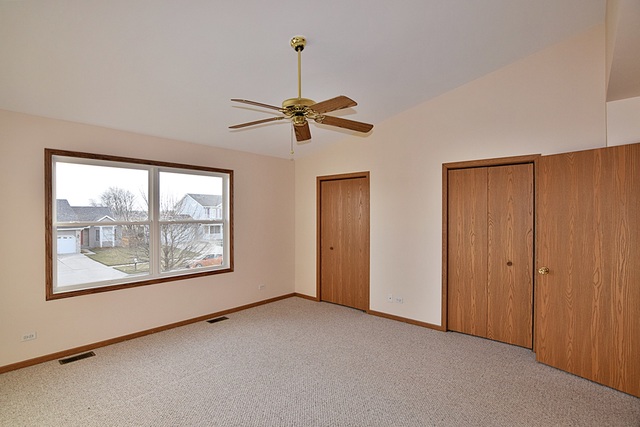 539 Elizabeth Street Maple Park, IL 60151 - Photo 16 of 25 an empty room with chandelier fan and windows