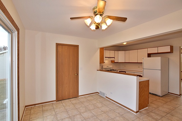 539 Elizabeth Street Maple Park, IL 60151 - Photo 7 of 25 a kitchen with stainless steel appliances granite countertop a refrigerator a stove and white cabinets
