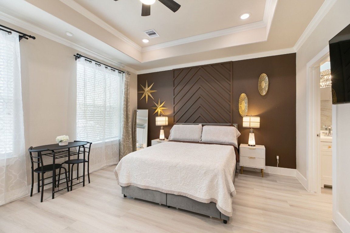 3514 Noah Street, Unit B Houston, TX 77021 - Photo 6 of 13 a bedroom with a bed and dresser with wooden floor