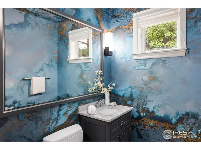 a bathroom with a sink mirror and vanity