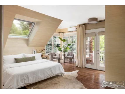 a living room with furniture and floor to ceiling windows