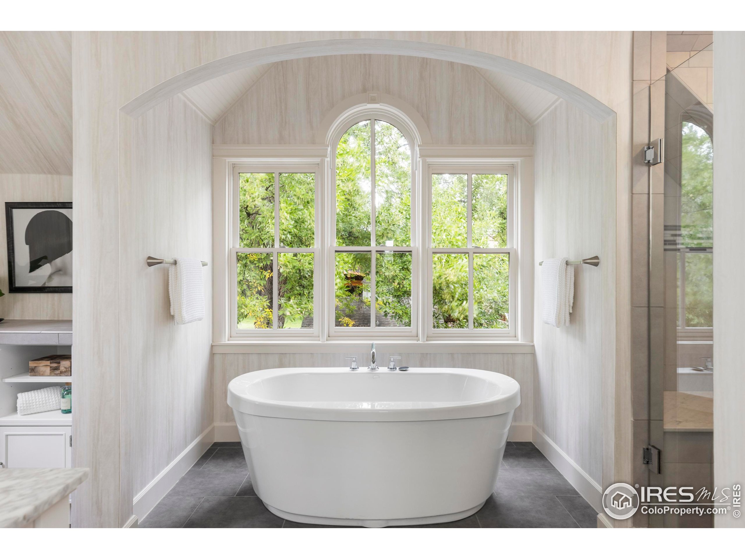 1070 Juniper Avenue Boulder, CO 80304 - Photo 17 of 32 a white bath tub sitting in a bathroom next to a window