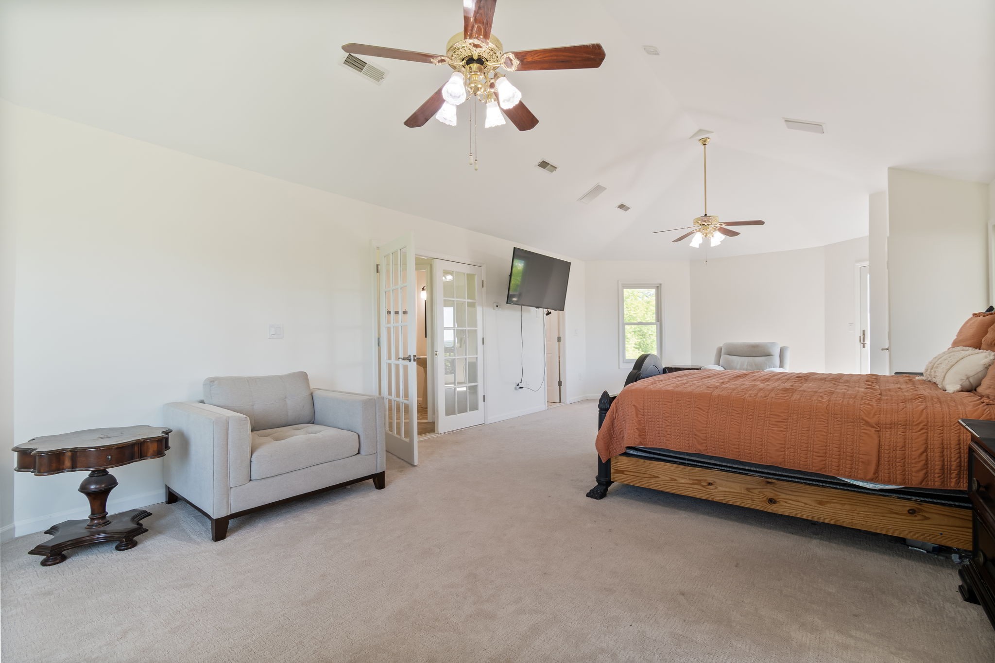 1979 Buck Daniels Road Culleoka, TN 38451 - Photo 35 of 61 a spacious bedroom with a bed a couch and a chandelier