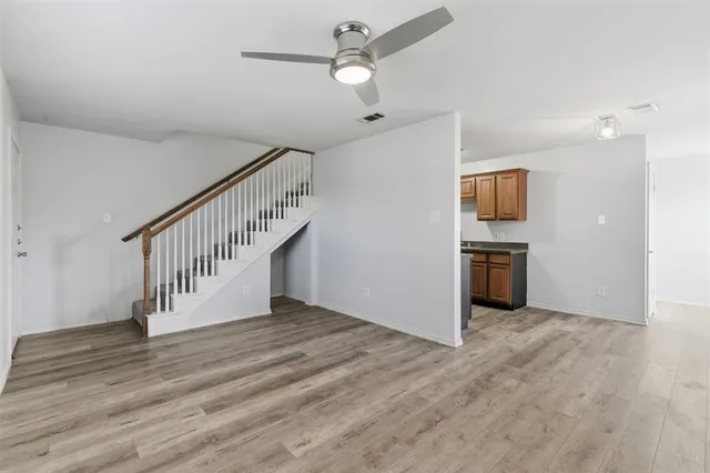 a view of entryway and kitchen with wooden floor