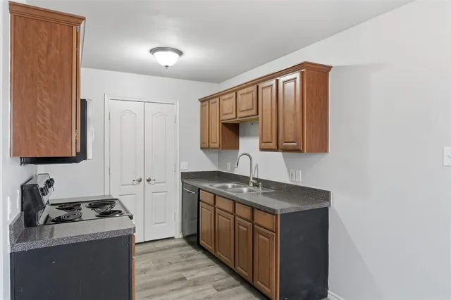 a kitchen with stainless steel appliances granite countertop a stove a sink and a microwave