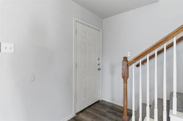 a view of a hallway with wooden floor and entryway