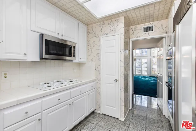 a view of a kitchen with cabinets stainless steel appliances