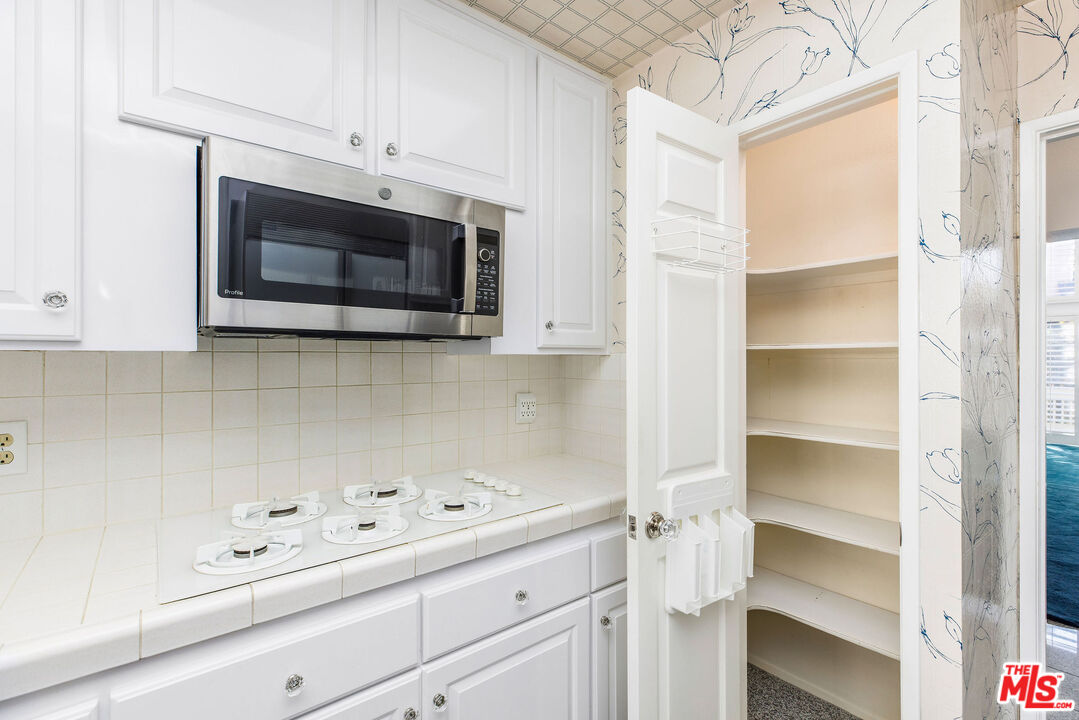 4342 Redwood Avenue, Unit C307 Marina del Rey, CA 90292 - Photo 14 of 48 a kitchen with white cabinets and appliances