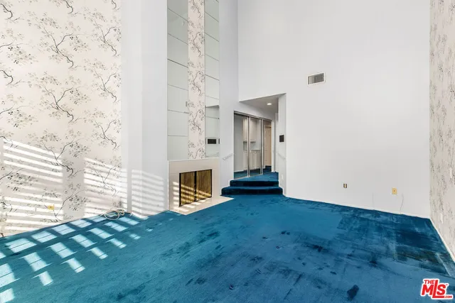 a view of an empty room with brick walls