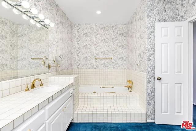 a bathroom with a bathtub and a sink