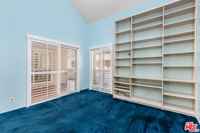 a view of wooden floor and windows in a room