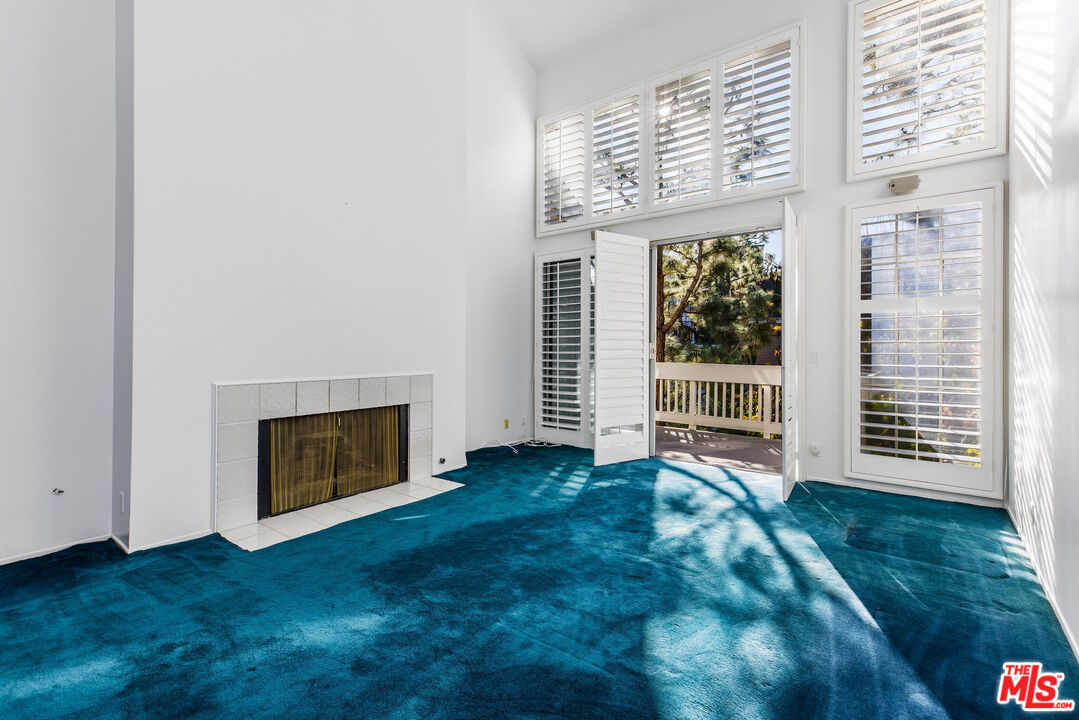 4342 Redwood Avenue, Unit C307 Marina del Rey, CA 90292 - Photo 3 of 48 a view of an empty room with a fireplace and a window