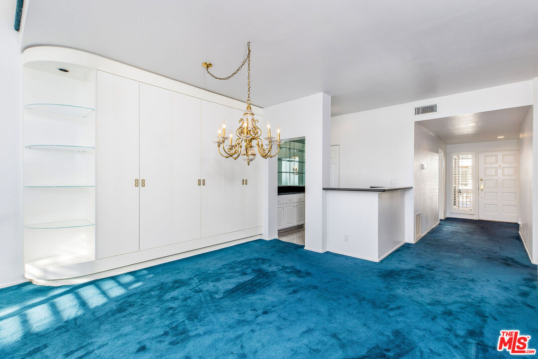 4342 Redwood Avenue, Unit C307 Marina del Rey, CA 90292 - Photo 6 of 48 a view of a kitchen with an empty room and wooden floor