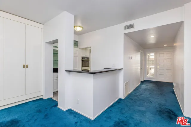a view of a kitchen with wooden floor and a sink