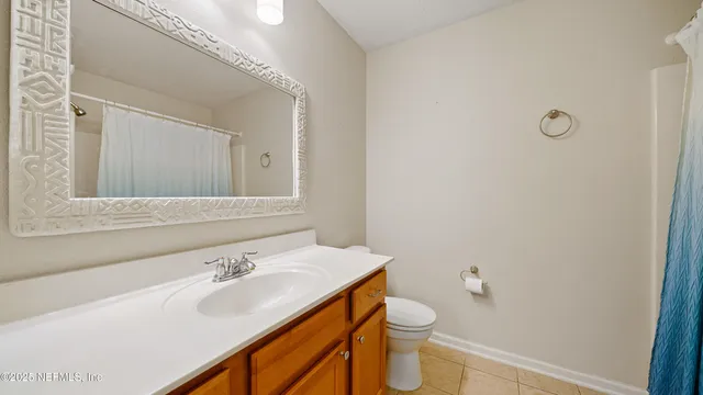 a bathroom with a sink toilet and mirror