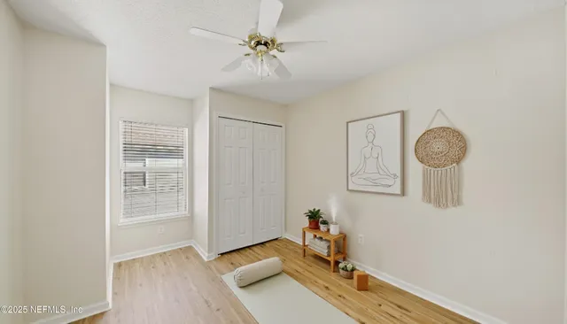 a view of room with window and wooden floor
