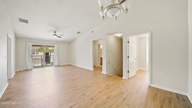 a view of a room with wooden floor and window