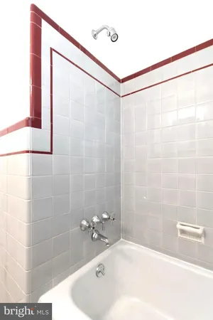 a bathroom with a bathtub and shower