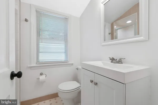 a bathroom with a sink toilet and mirror