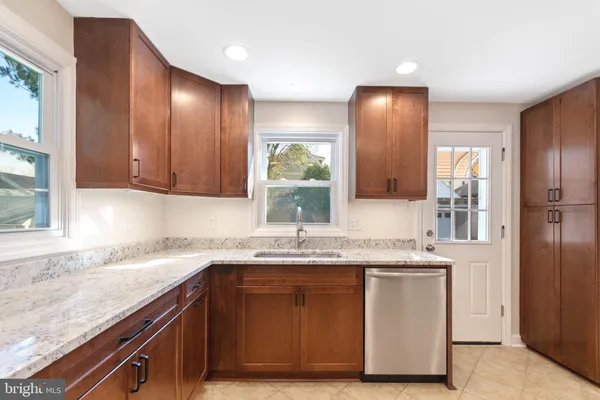 a kitchen with a sink cabinets and window